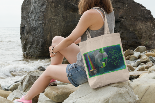 Happy St. Patrick's Day Manatee Tote Bag, model sitting on rocks by ocean