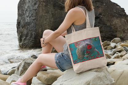 Happy Valentines Day Manatee Tote Bag, model sitting on rocks by ocean