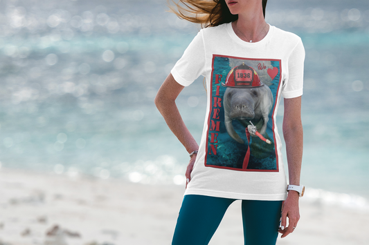 Fireman Manatee Tee, model wearing white t-shirt on beach