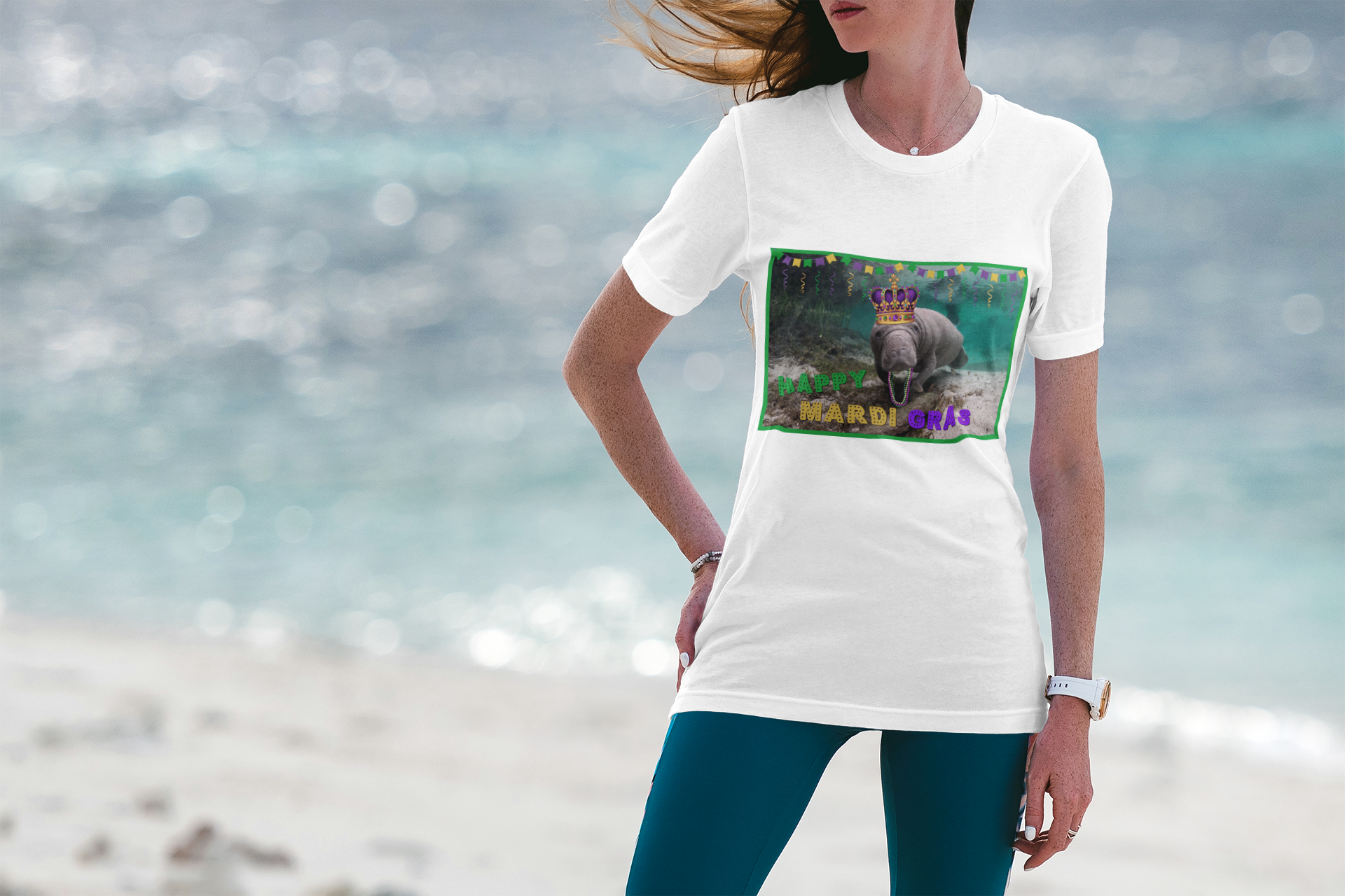 Happy Mardi Gras Manatee Tee, model wearing white t-shirt on beach