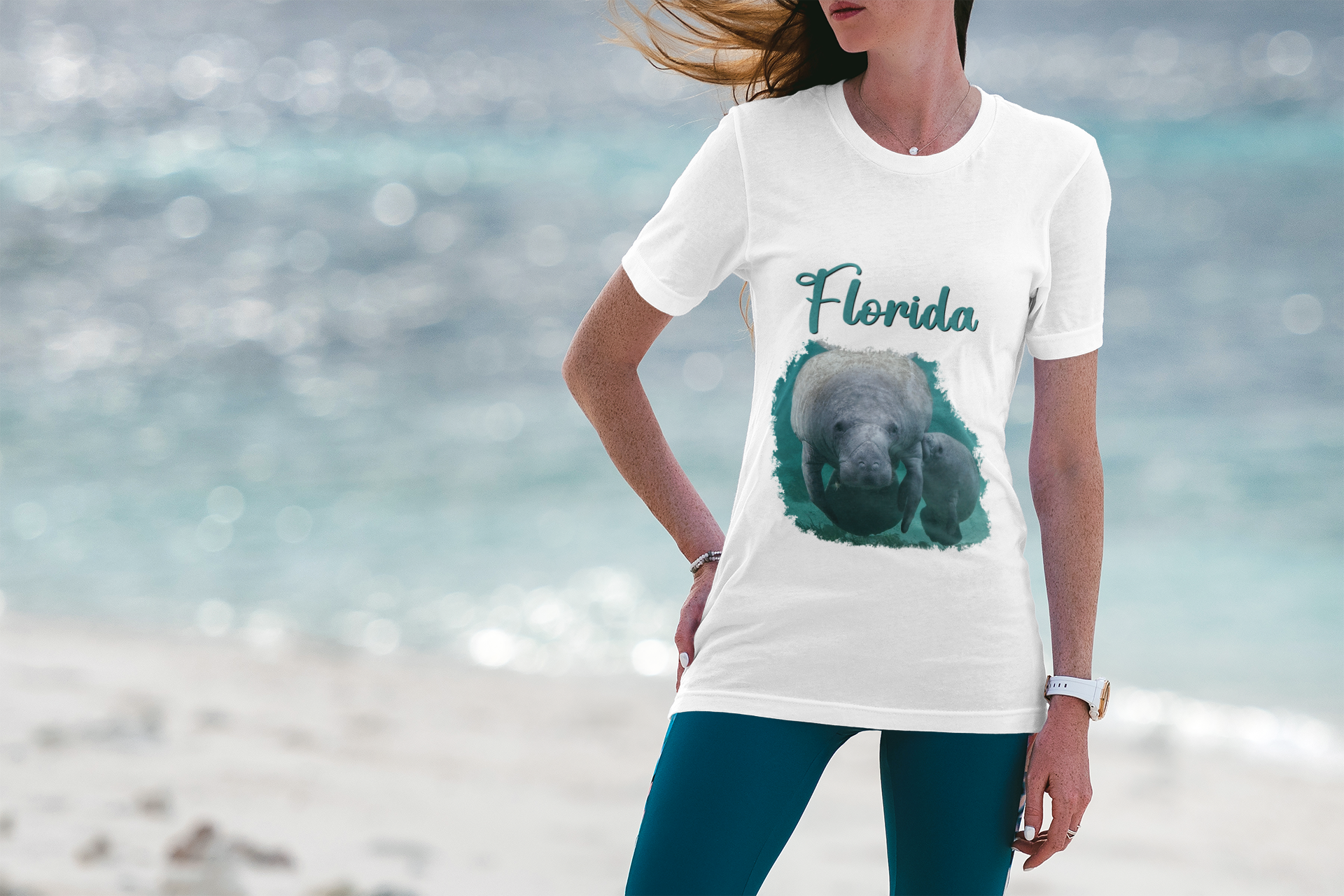 Manatee and Calf feeding Tee, model wearing white t-shirt on the beach